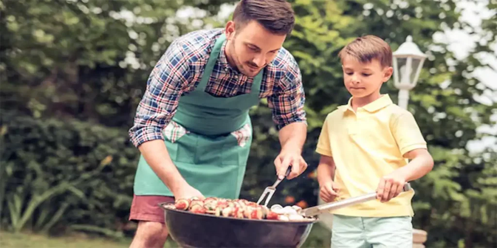 Father's Day Father Son Barbecuing in Backyard Summer Family Vacation Time